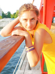 Erotic picture of Lovely teen beauty showing perky tits and playful pussy under sexy yellow dress on public.