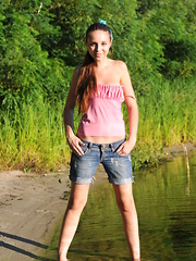 Erotic picture of This shapely brunette teen makes a place of nature even more beautiful with her naked body and posing in the sand.