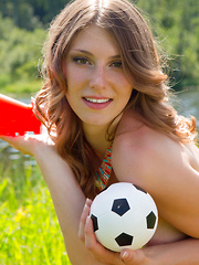 Erotic picture of Sexy brunette spreads her legs in the sunshine by the pond, feeling true lustfulness and passion while she does poses.