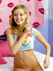 Erotic picture of Teenage blonde hottie rubs her damp muff in her bedroom