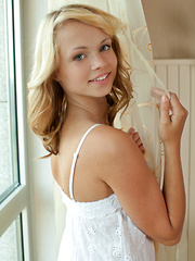 Erotic picture of Eve B gets intimate infront of the camera, slowly stripping off her white dress and panty before showcasing her smooth, nubile body.