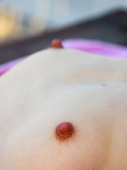 Erotic picture of Just give a few glimpses to her tight teen pussy as she burns with lust and passion while showing it off.