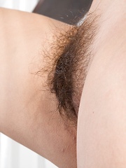 Erotic picture of Watch the sexy Baby Lizza strip naked on sofa