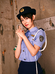Erotic picture of Rina Akiyama Asian in police woman uniform exposes sexy legs