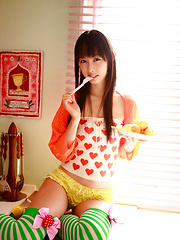 Erotic picture of Rina Akiyama Asian in long colorful socks enjoys some sweets