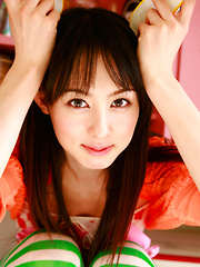 Erotic picture of Rina Akiyama Asian in long colorful socks enjoys some sweets