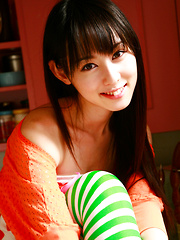 Erotic picture of Rina Akiyama Asian in long colorful socks enjoys some sweets